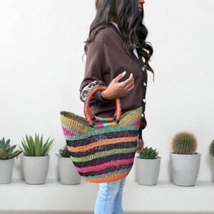 Woman holding a basket in her arm, made with natural materials