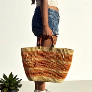 Young woman holding African basket