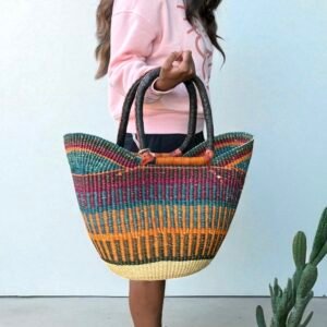 Girl holding in a shopping basket, handmade with elephant grass