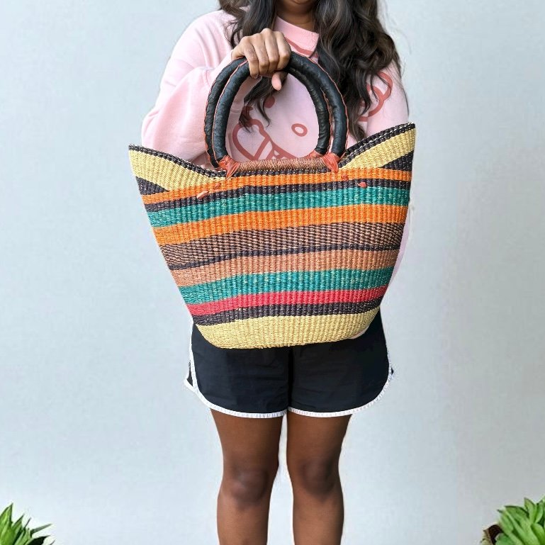 Girl showing shopping basket handmade with many colors